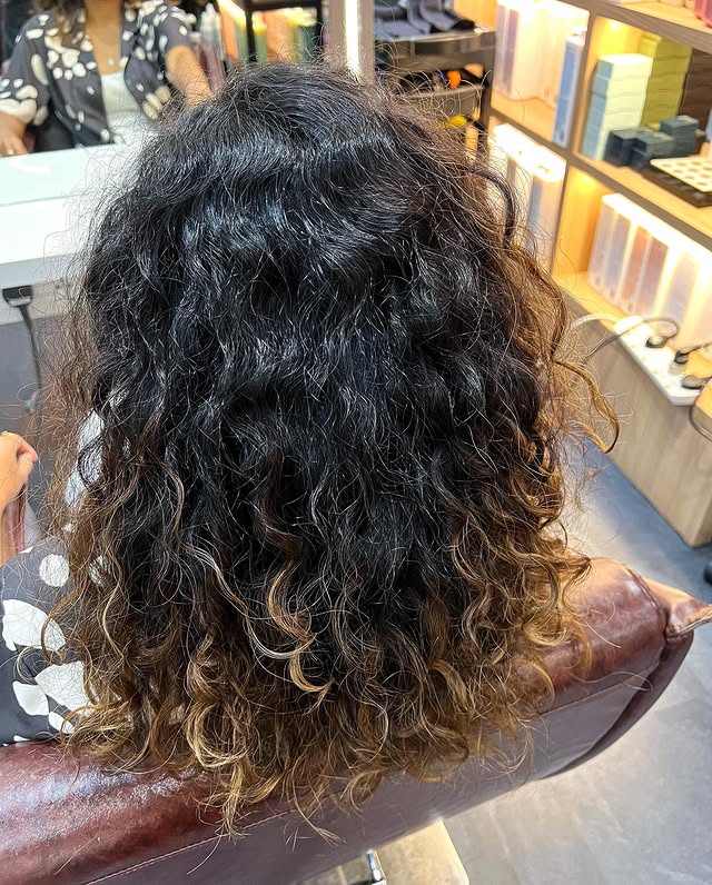 Voluminous Curls With Golden Highlights